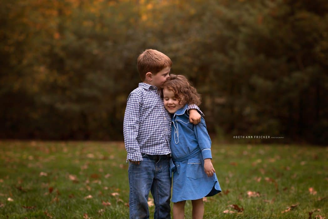 Siblings showing affection Bedford MA Family  Photographer