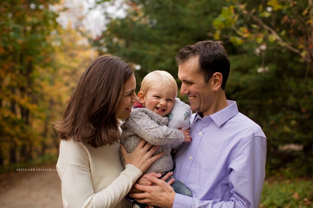 family of three outside in the fall Newton MA Family Photographer
