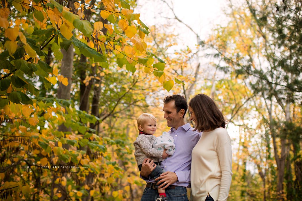 family of three outside in the fall Newton MA Family Photographer