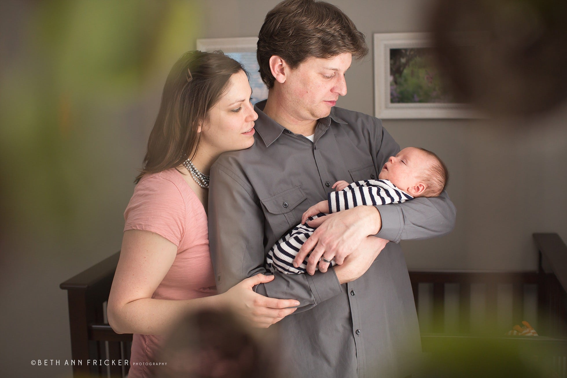 new family of three in nursery boston newborn lifestyle photographer