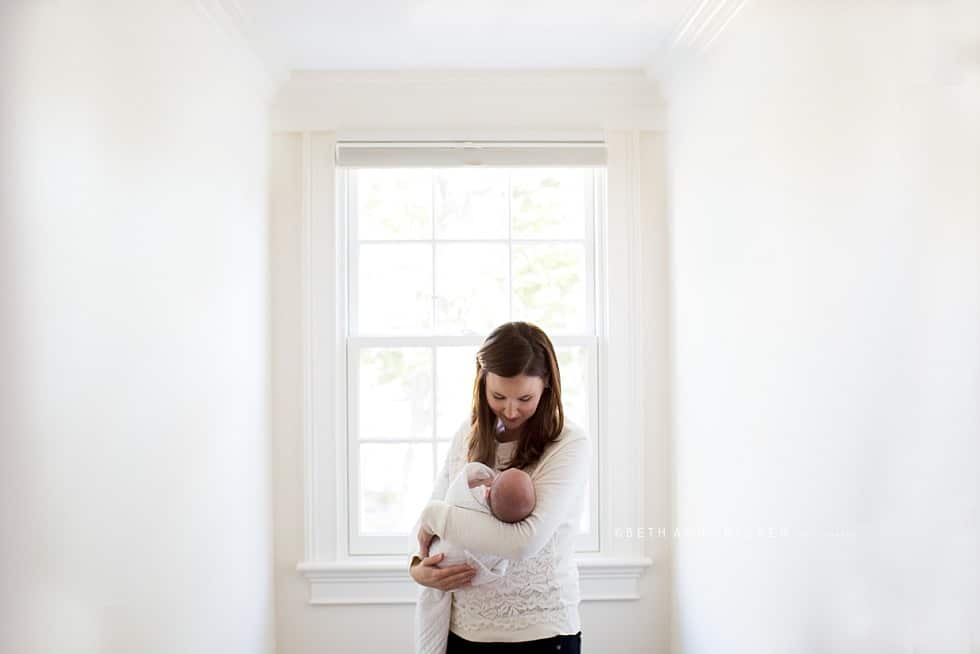 Mom holding baby Wellesley Newborn photographer