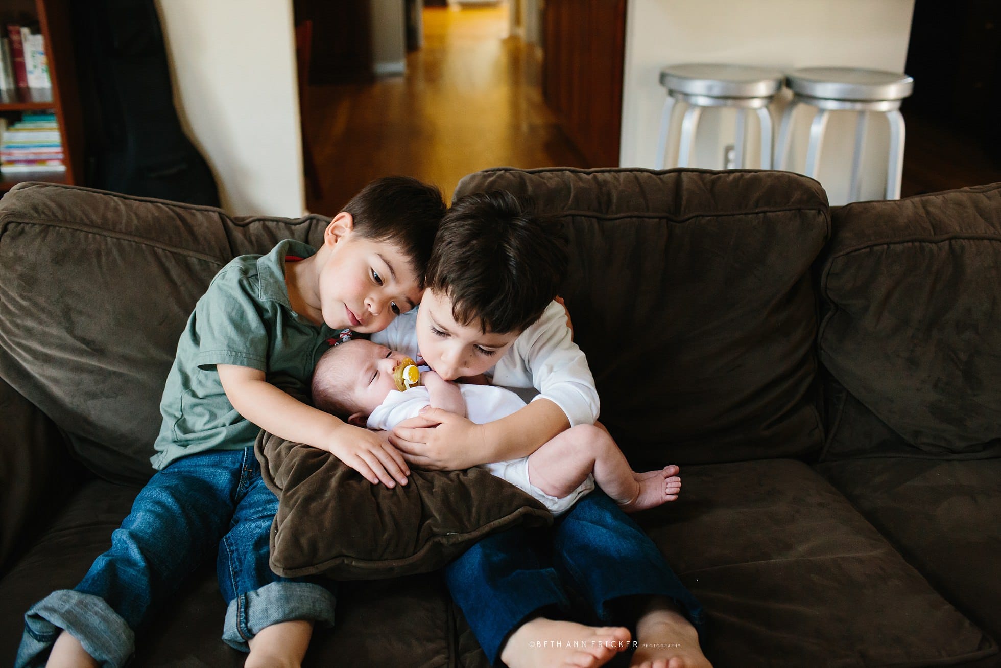 older sibling twins holding newborn baby sister Boston Baby Photos