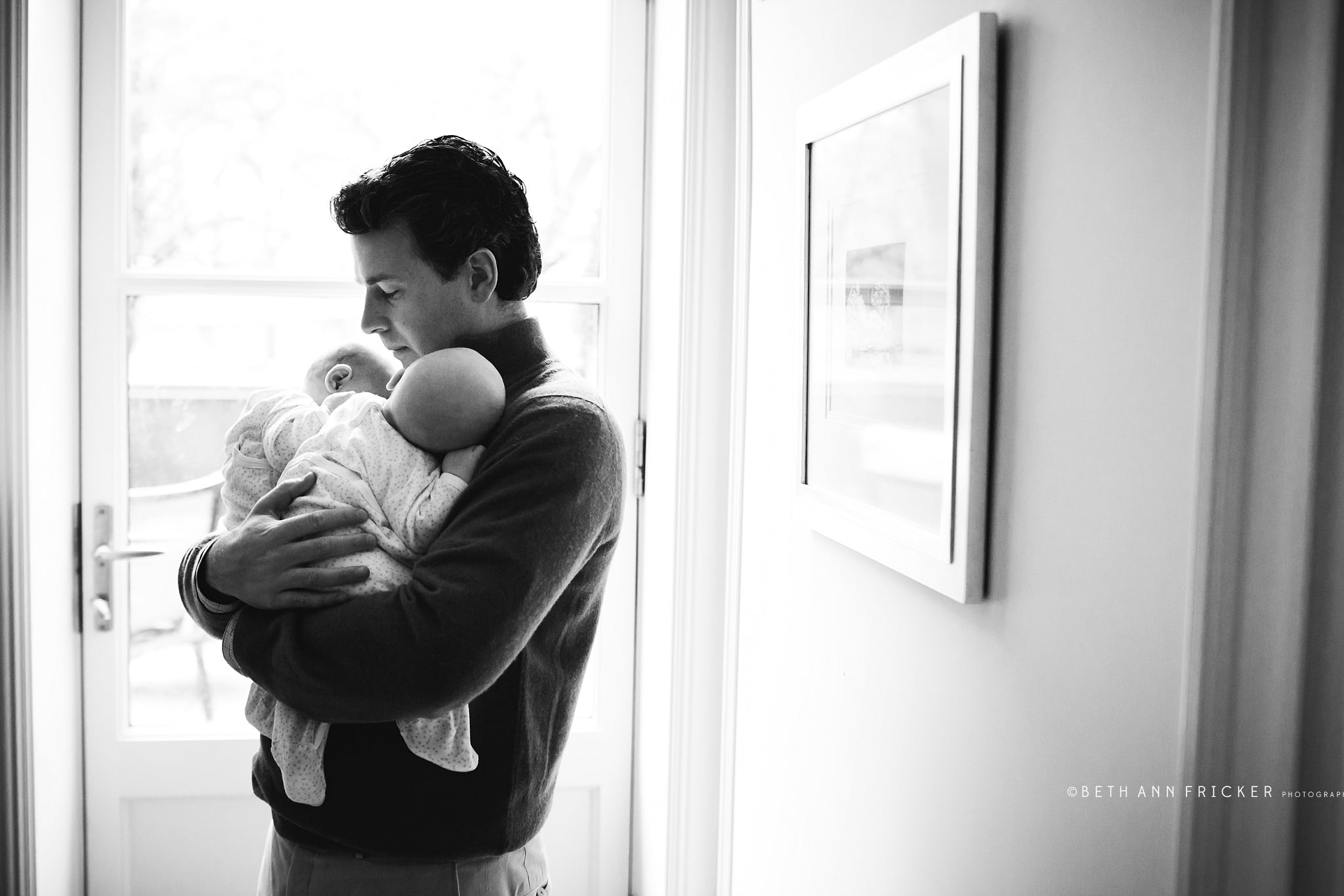black and white image of dad holding babies Massachusetts newborn photographer