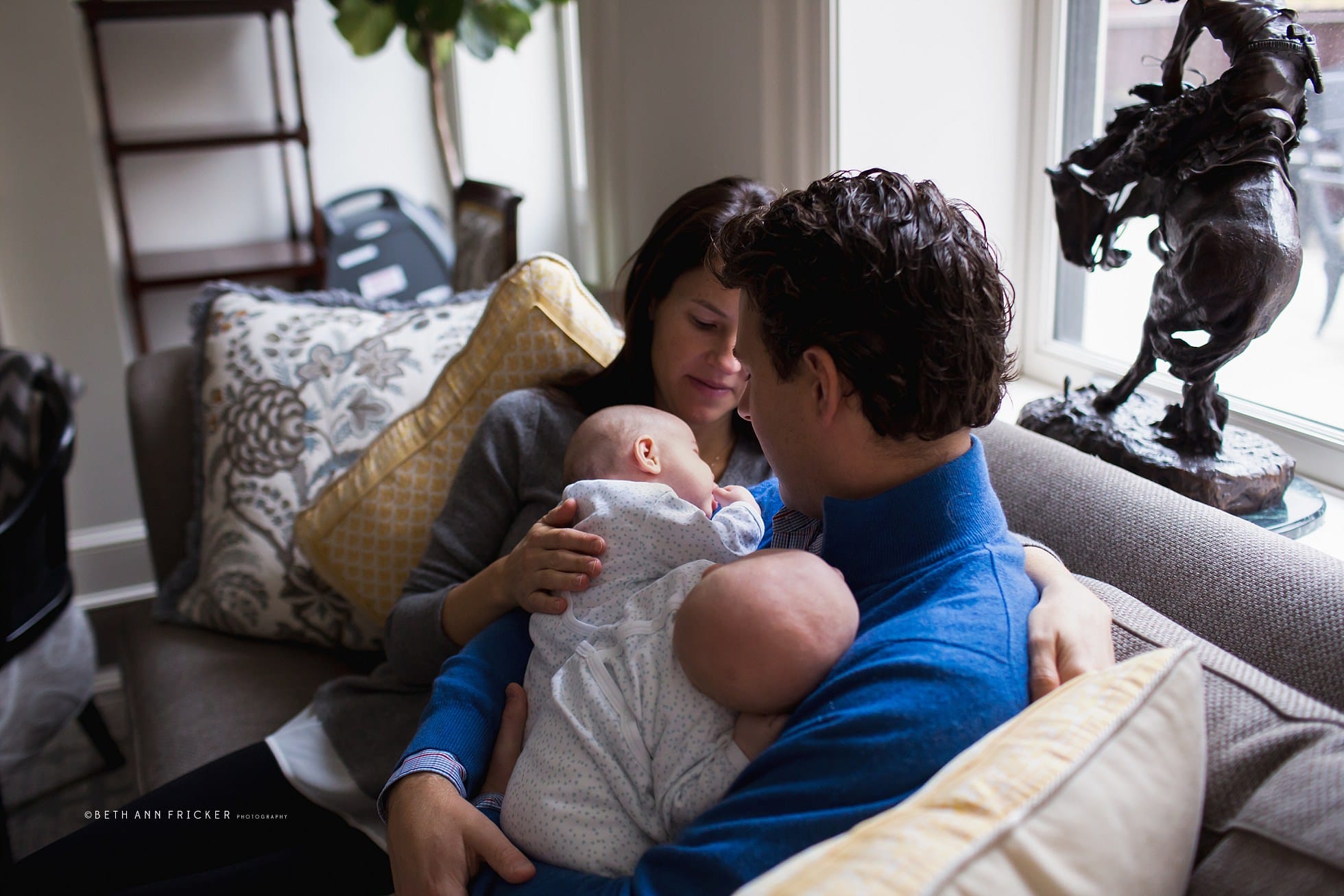Sitting on living room couch with newborn twins Massachusetts Newborn Photographer