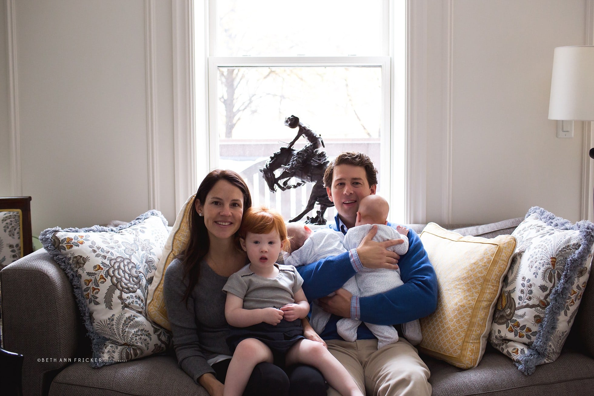 Family of five sitting on couch with newborn twins Boston Newborn Photos