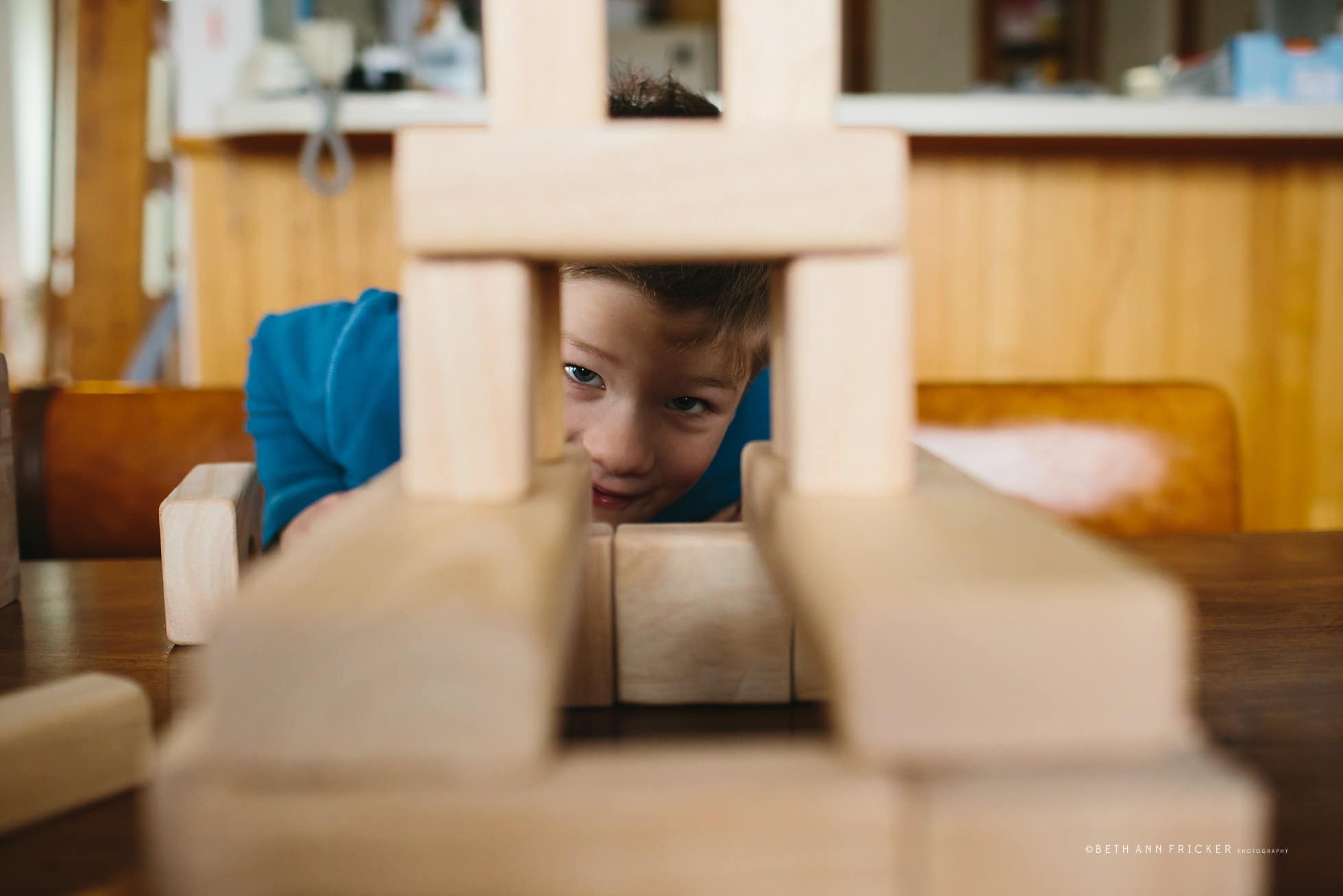 building a tower with wooden blocks boston child photographer