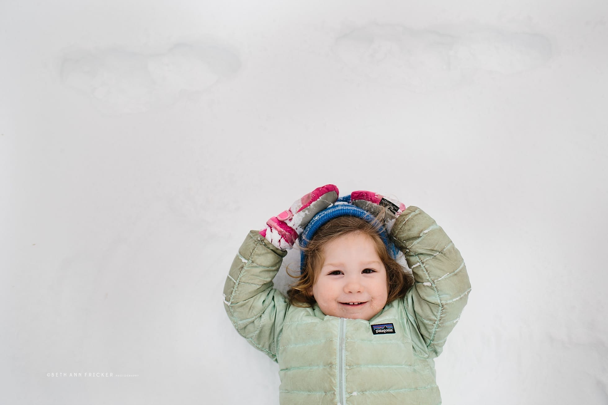 girl making snow angel boston child photographer