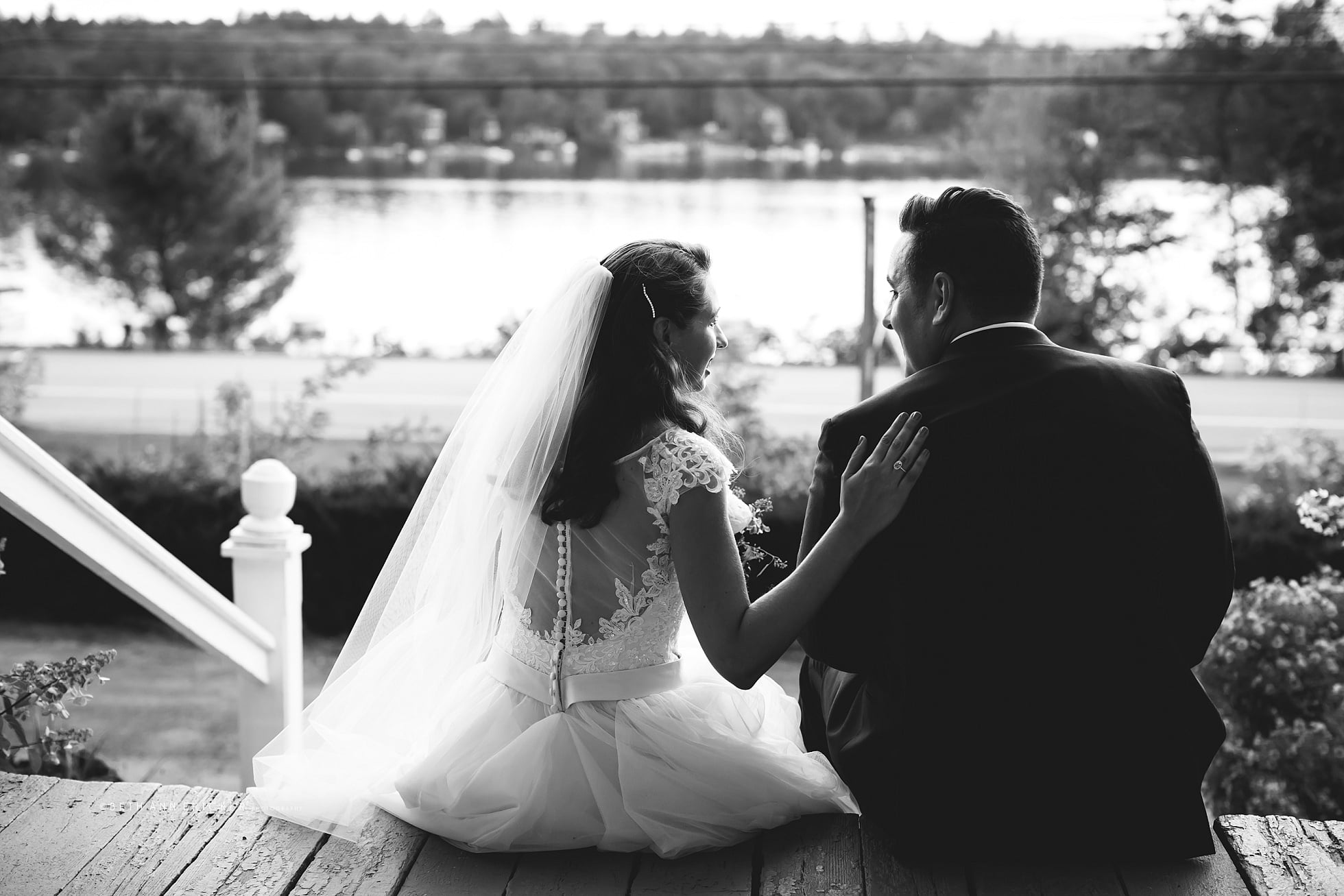 Bride and Groom looking out the sunset Inn on Newfound Lake Wedding Photographer