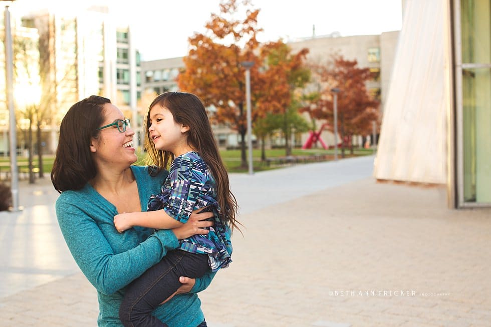 daughter in mom's arms outside of Stata buidling Cambridge MA Family photographer