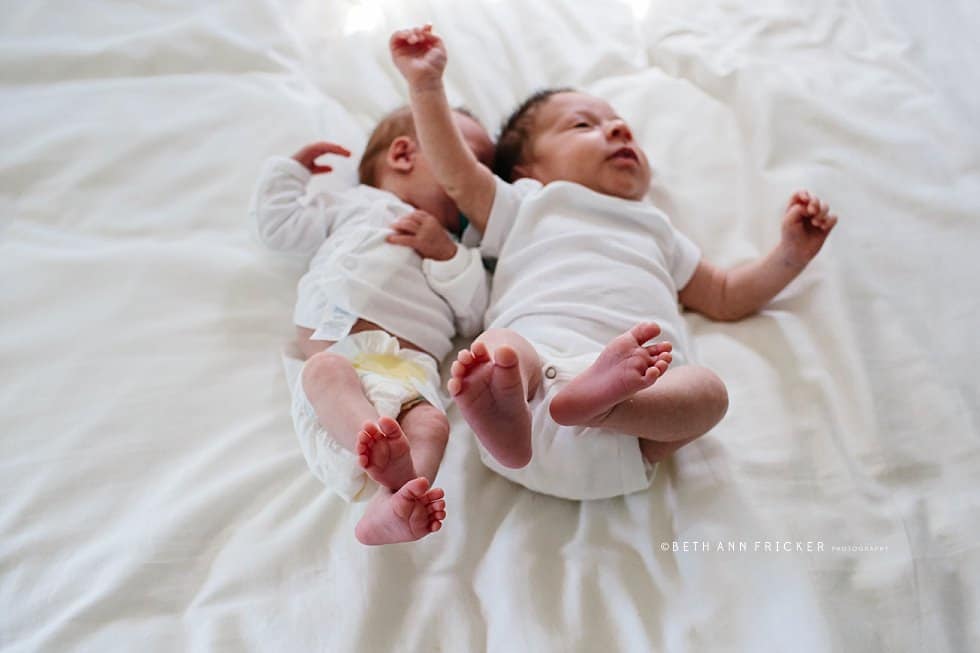 newborn twins laying on a bed Natick newborn photographer