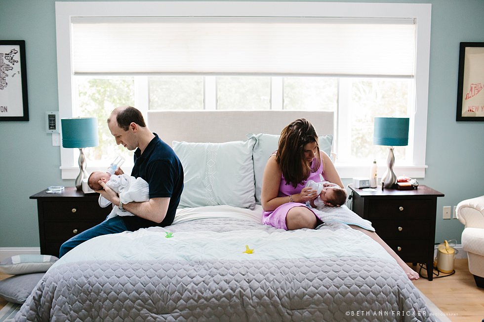 mom and dad feeding newborn twins Natick newborn photographer
