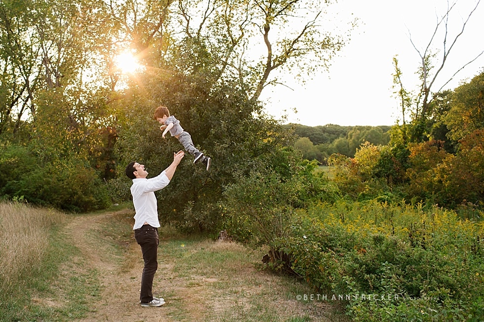 boy being thrown in air by dad Newton family photographer