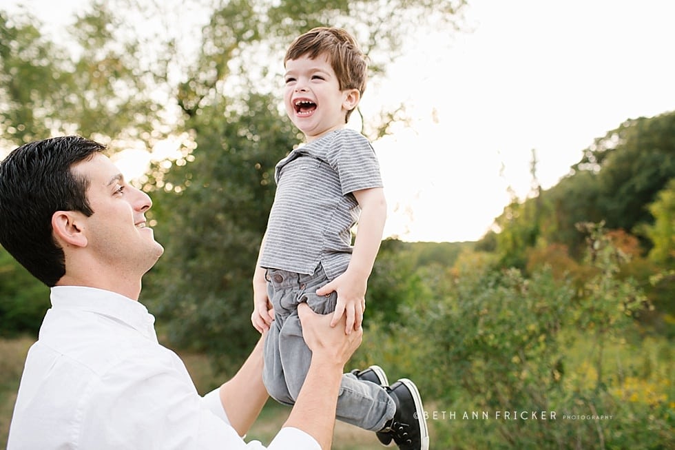 boy being thrown in air by dad Newton family photographer