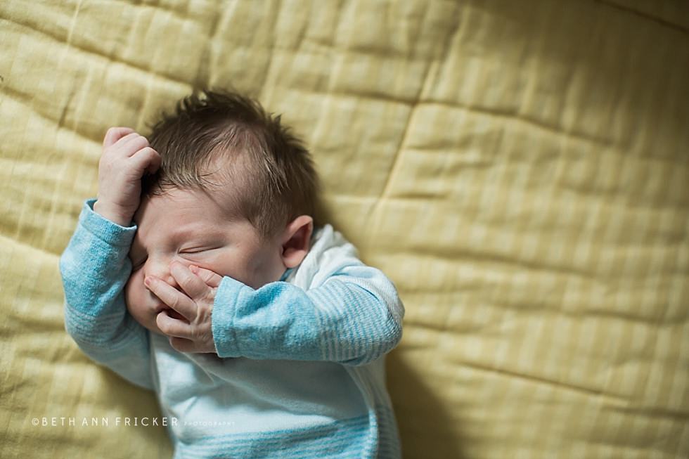 newborn baby on yellow blanket boston newborn photographer