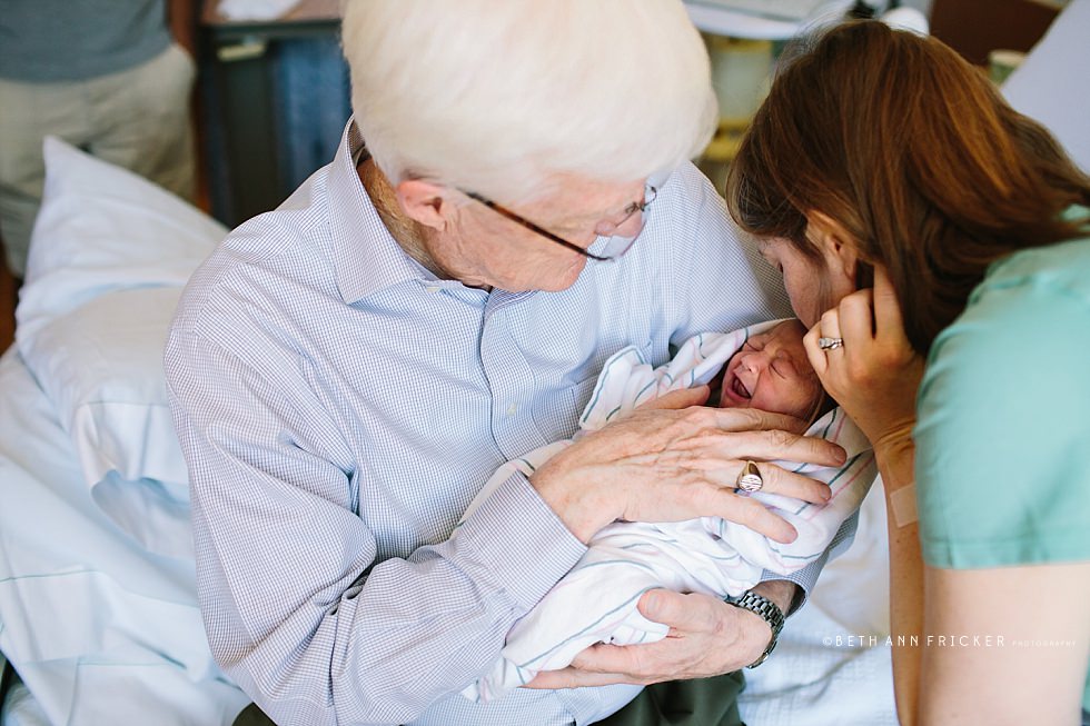 grandfather holding granddaughter in the hospital Boston newborn photographer