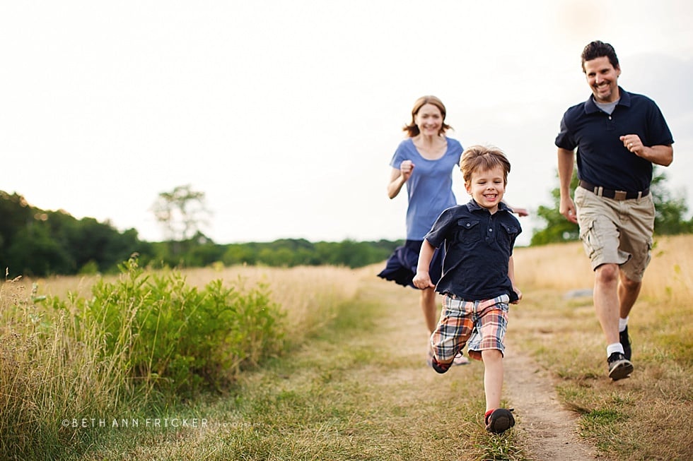 family of three running in a field Boston Family Photographer