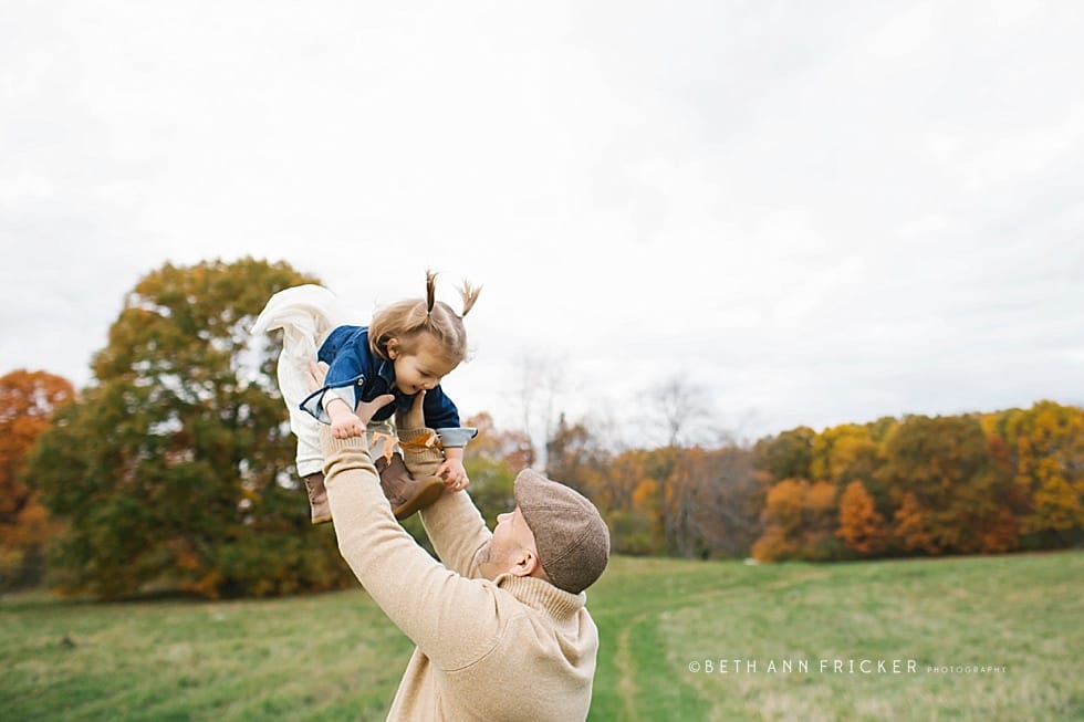 dad tossing his daughter in the air Boston family photographer