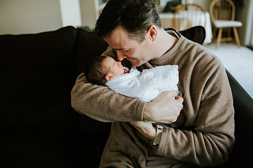 dad holding newborn baby girl Concord Newborn PHotographer