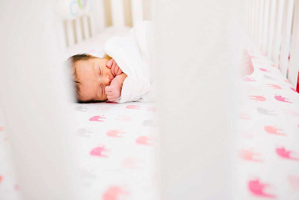 newborn baby girl in crib Boston Newborn PHotographer