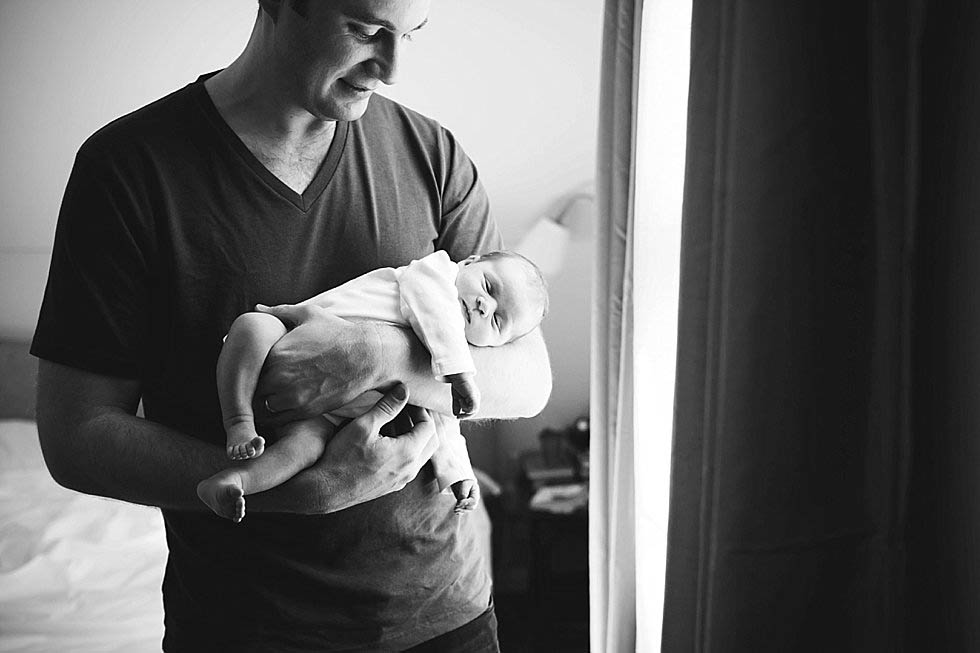 dad holding newborn son Newton Newborn photographer