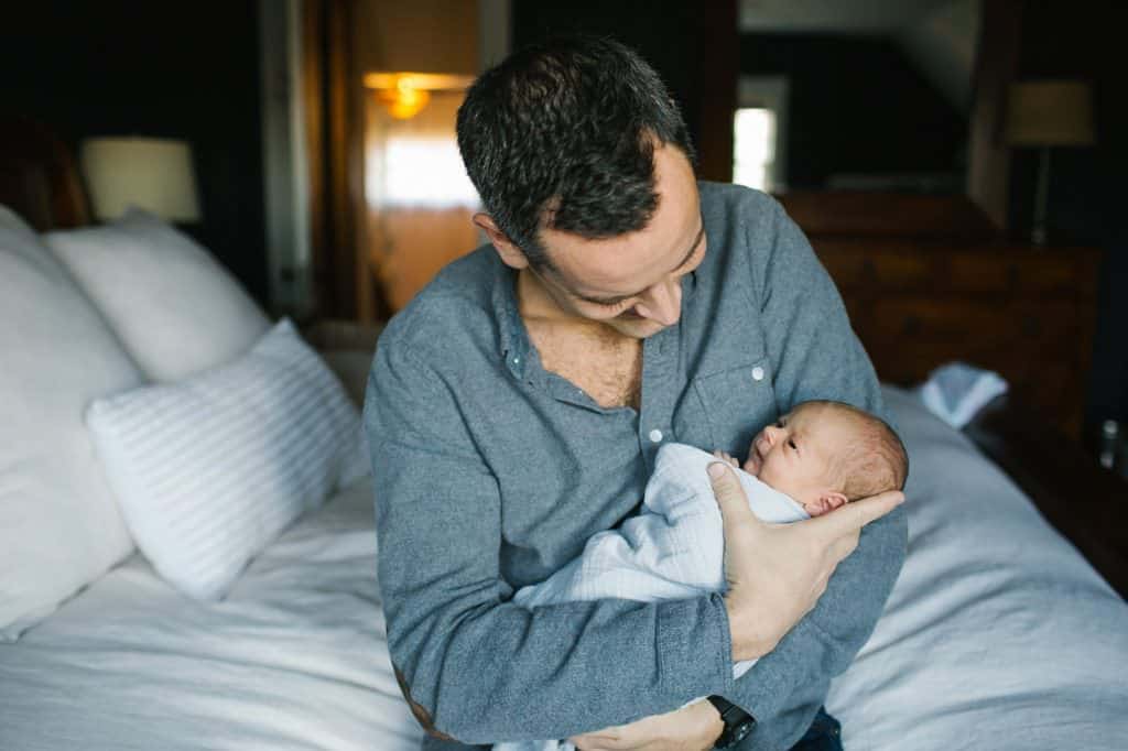 dad holding newborn baby daughter Boston Newborn photographer