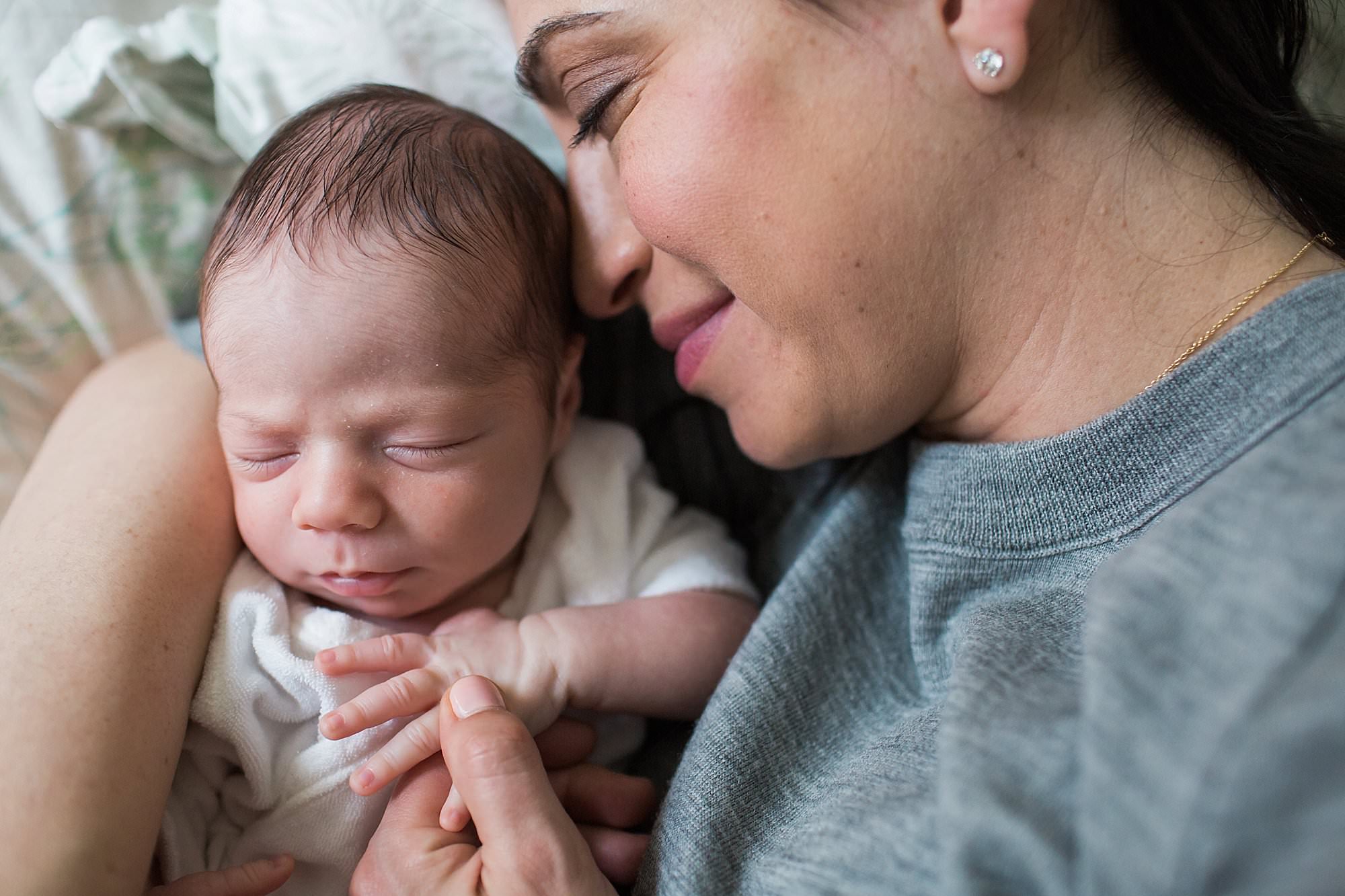 mom snuggling newborn son boston newborn photographer