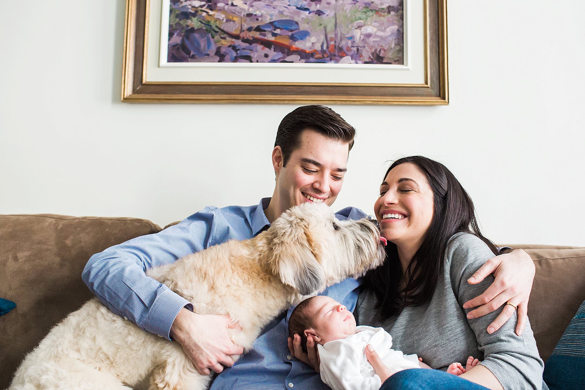 dog licking mom's face while holding newborn baby boston Boston natural indoor home session