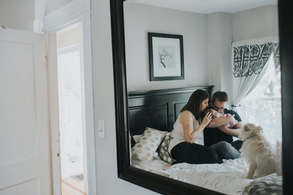 parents with newborn mirror reflection Boston Baby photos