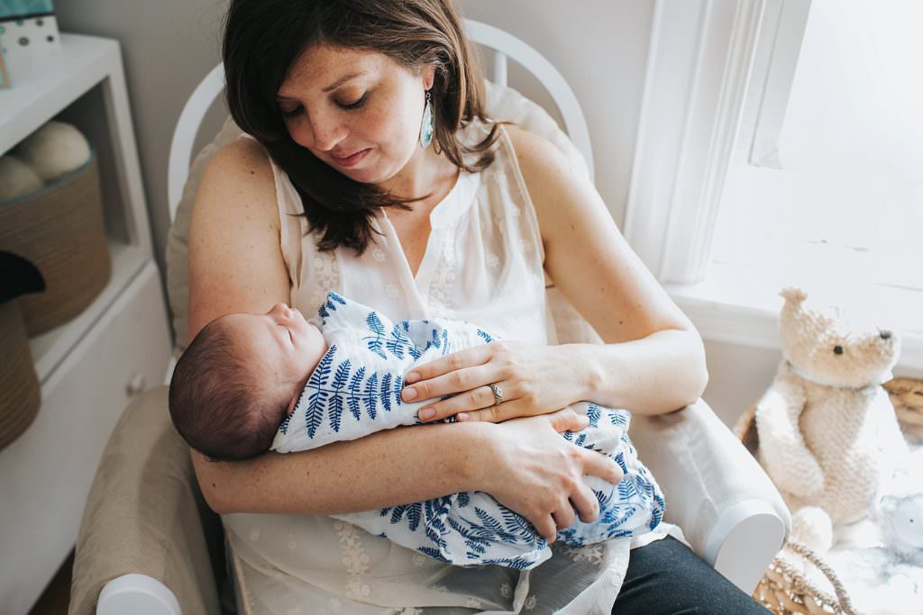 newborn in mom's arms in the nursery Boston Baby photos