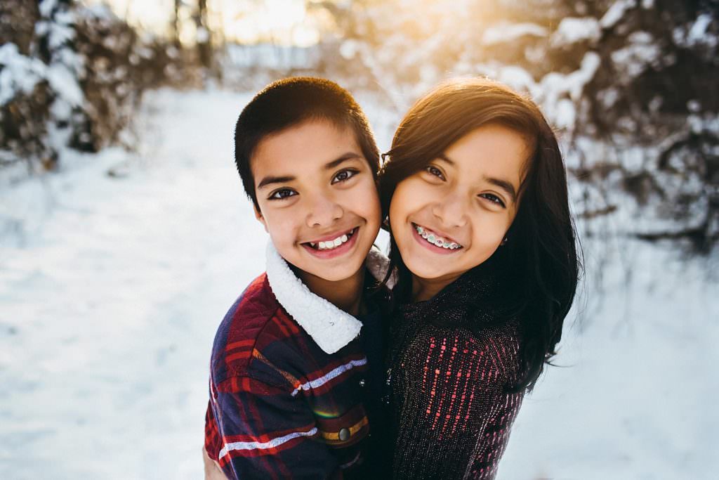 siblings playing in the snow Massachusetts Family photographer