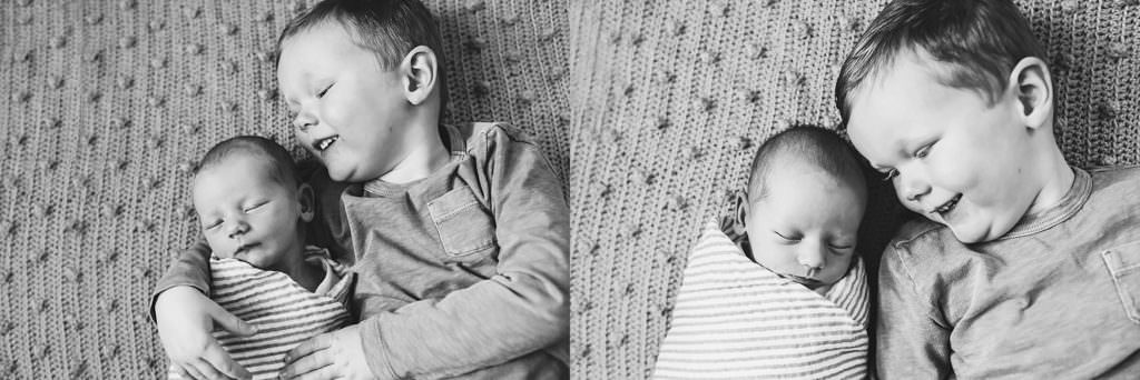 big brother holding baby brother Medford Newborn photographer