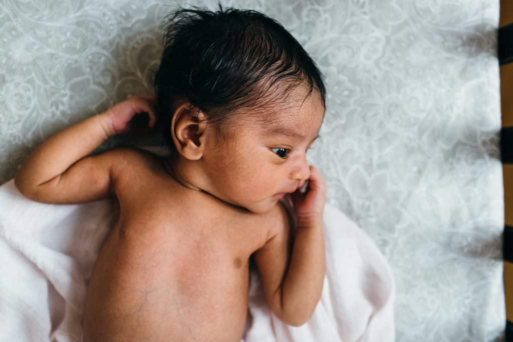 baby in her cribs Bedford Newborn Photographer