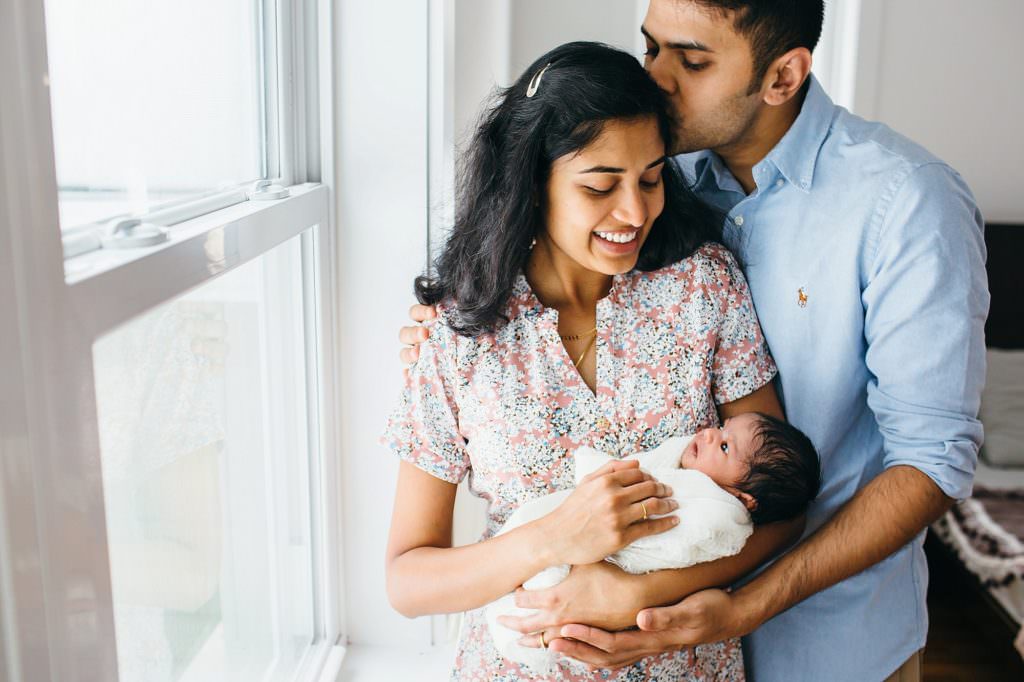 mom and dad holding baby Bedford Newborn Photographer