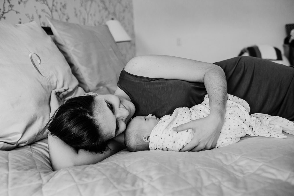 mom lying with baby Hingham newborn photographer