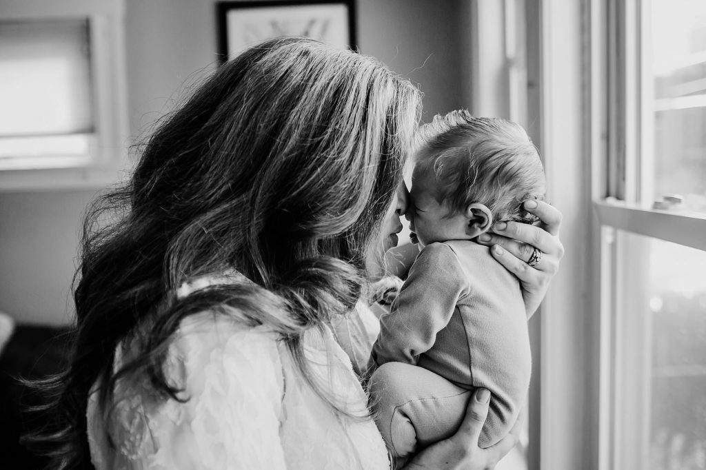 mom kissing baby Medford newborn photographer 