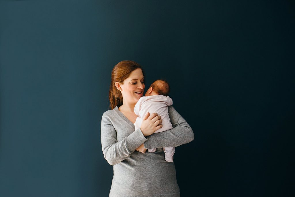 mom holding baby Melrose newborn photographer