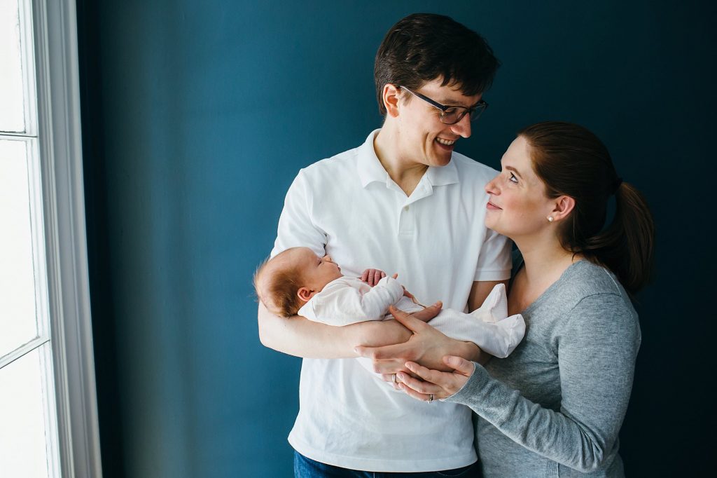 mom and dad holding baby Melrose newborn photographer