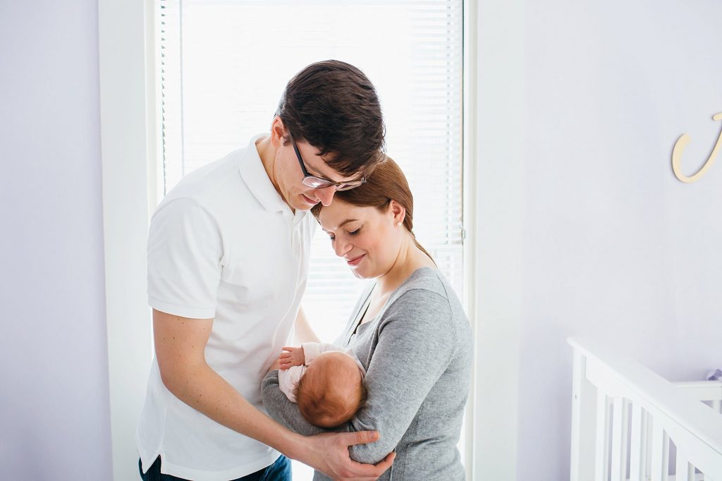 mom and dad holding baby Melrose newborn photographer