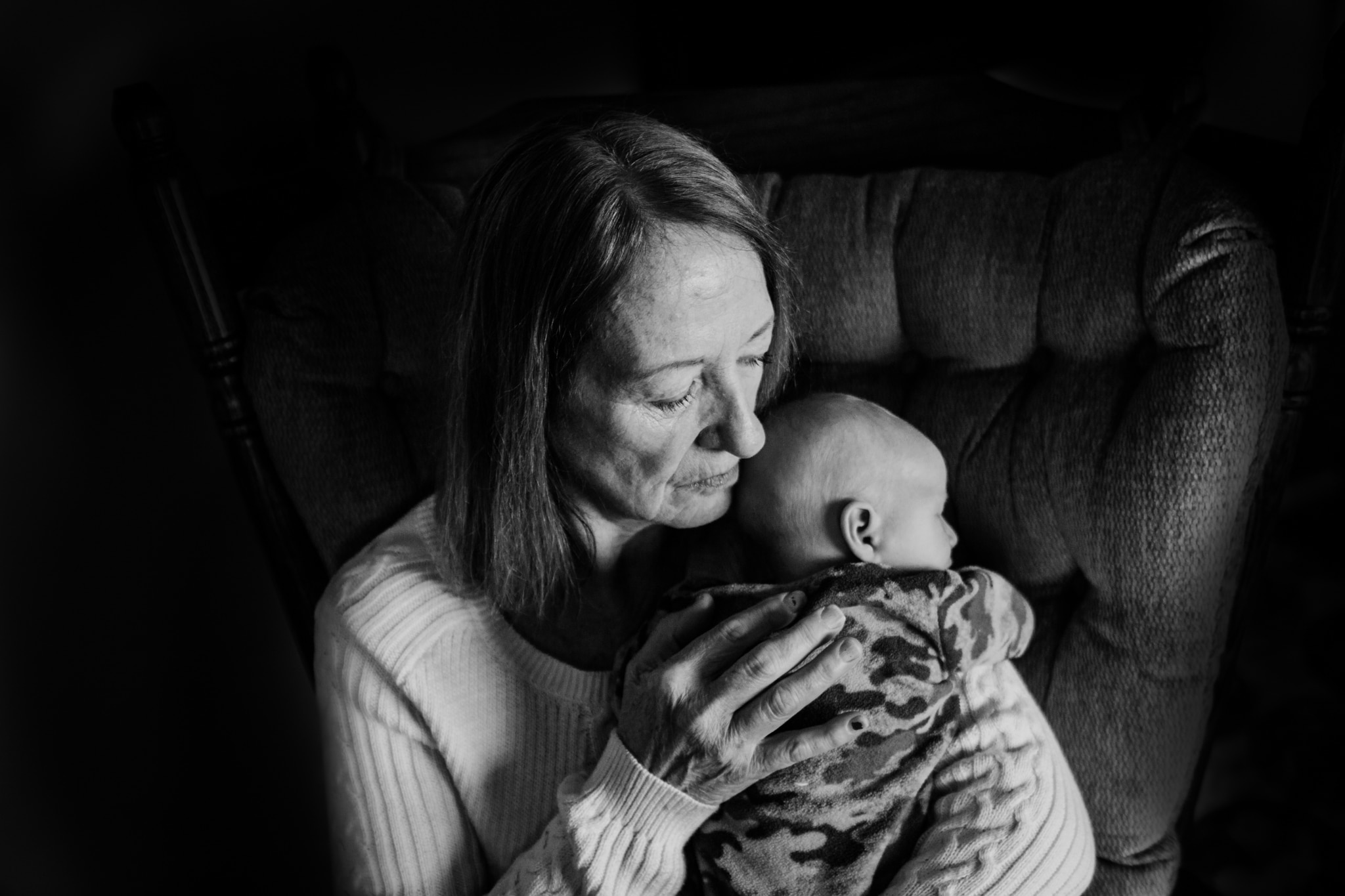 grandmother holding grandson rochester newborn photographer