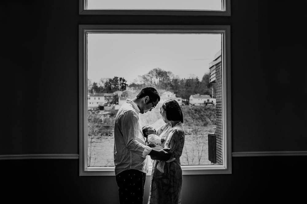 silhouette of parents holding baby Lowell Newborn Photos