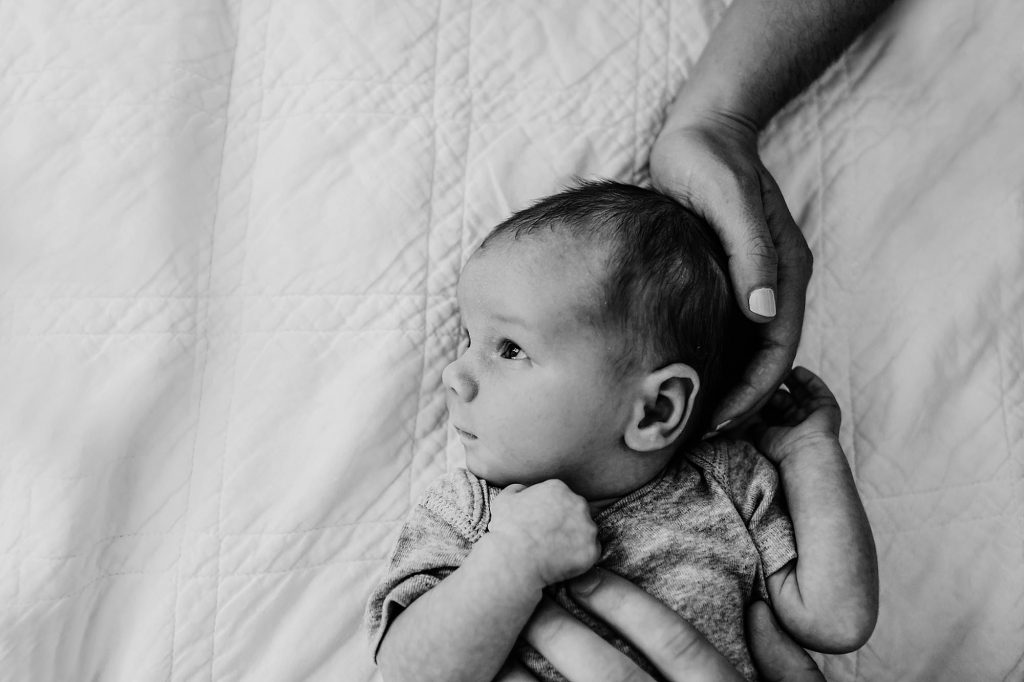 parents with hands on baby Newburyport Newborn Photographer