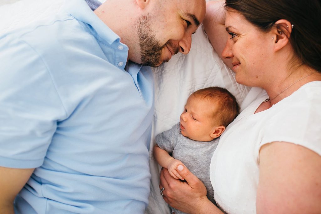 Mom and dad smiling at each other Newburyport Newborn Photographer