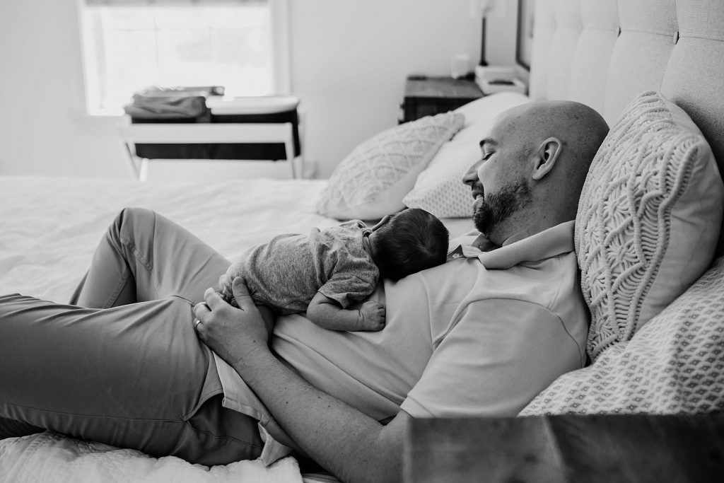 dad laying with baby Newburyport Newborn Photographer