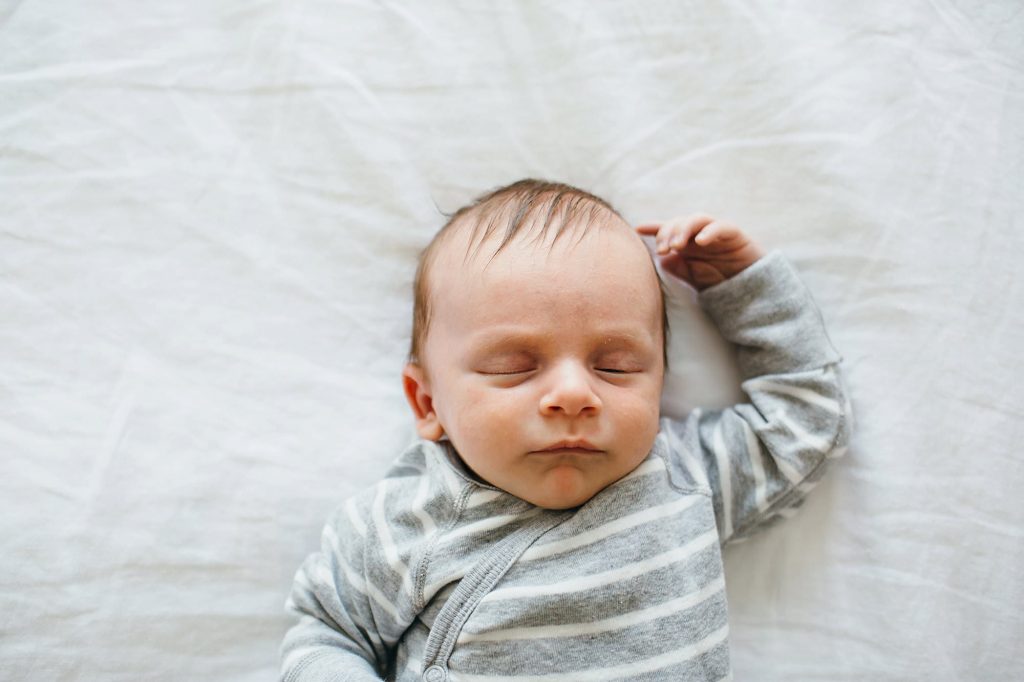 baby sleeping on bed Charlestown Newborn Photographer