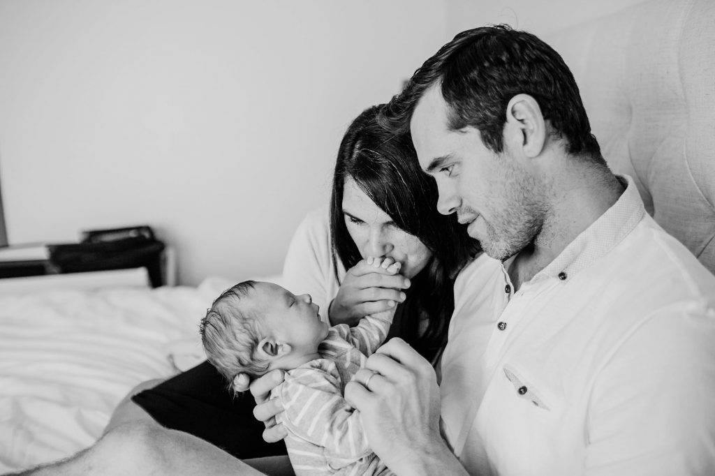 mom kissing baby's hands Charlestown Newborn Photographer