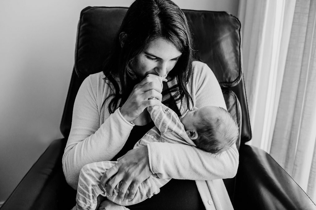 mom kissing baby's hand Charlestown Newborn Photographer