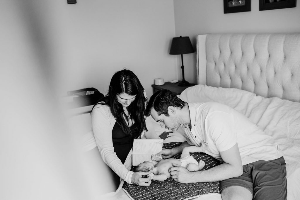 parents reading to baby  Charlestown Newborn Photographer
