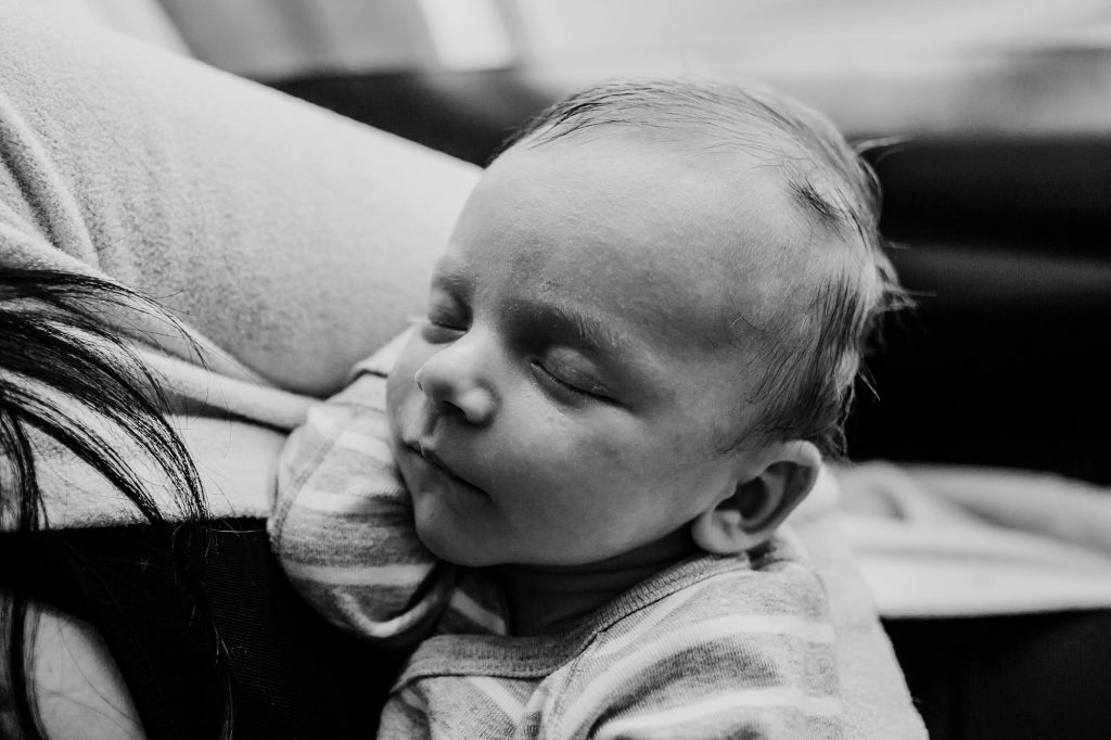 baby sleeping in mom's arms Charlestown Newborn Photographer