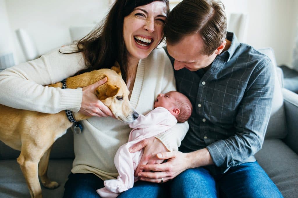 mom laughing with baby and family charlestown newborn photographer