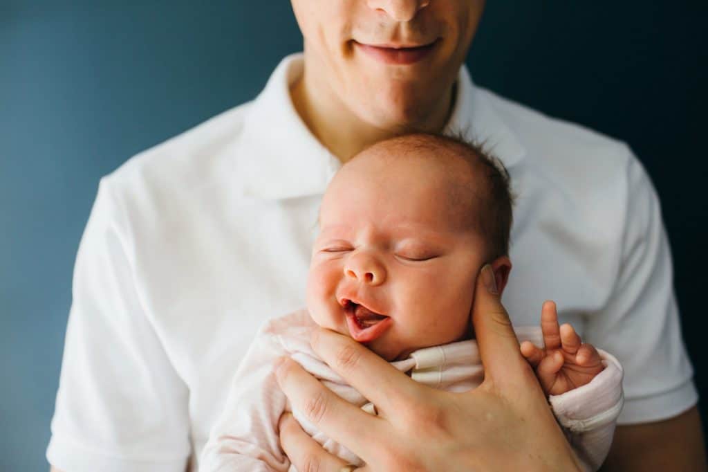 dad holding newborn daughter melrose baby photographer
